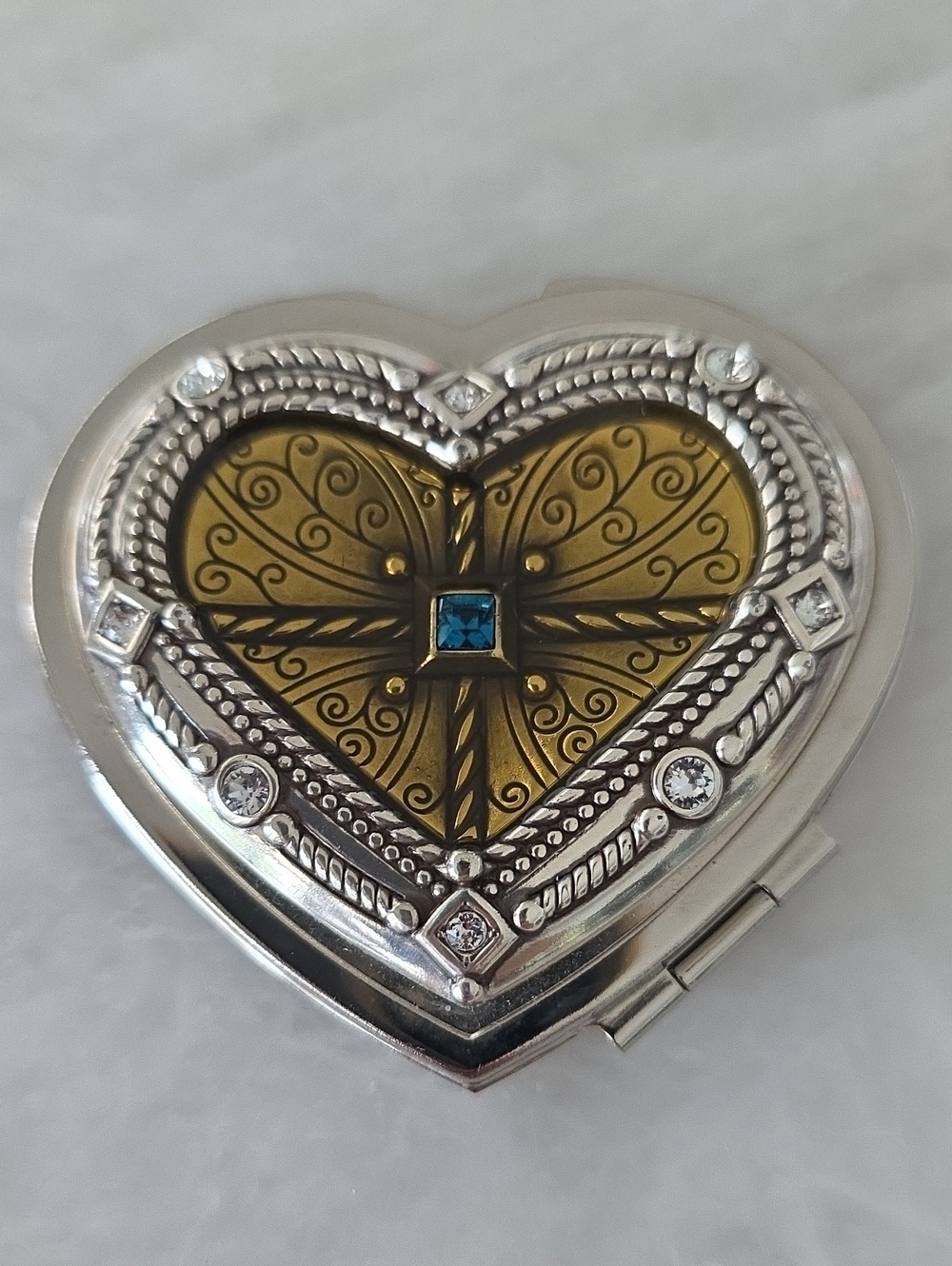 Brighton Heart-Shaped Silver and Gold Dual Mirror Compact with Blue Accent.